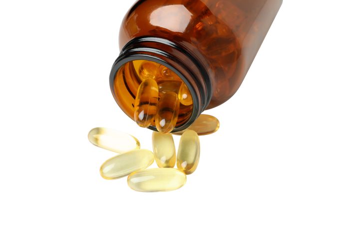 Brown bottle with omega pills, isolated on blank background