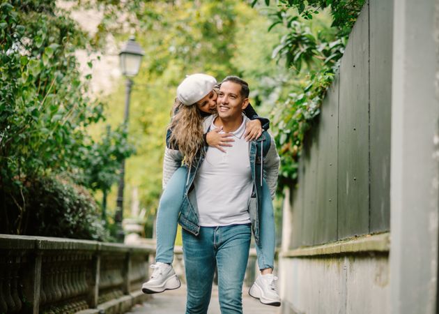 Happy couple having fun together at overgrown city street