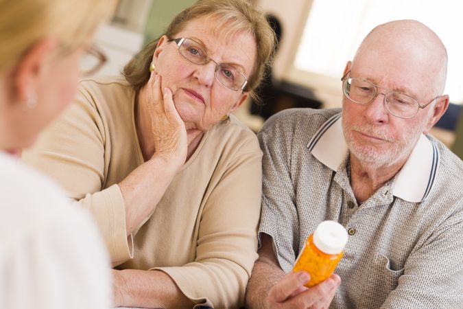 Doctor or Nurse Explaining Prescription Medicine to Older Couple