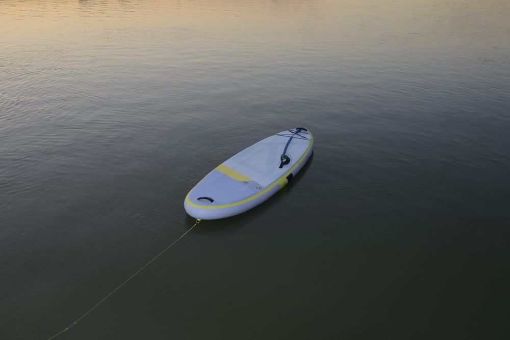 Paddleboard on lake with rope