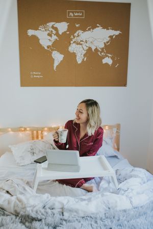 Woman sitting in bed with tablet