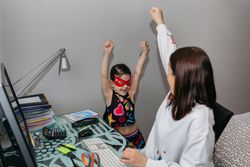 Woman teleworking and playing with her daughter