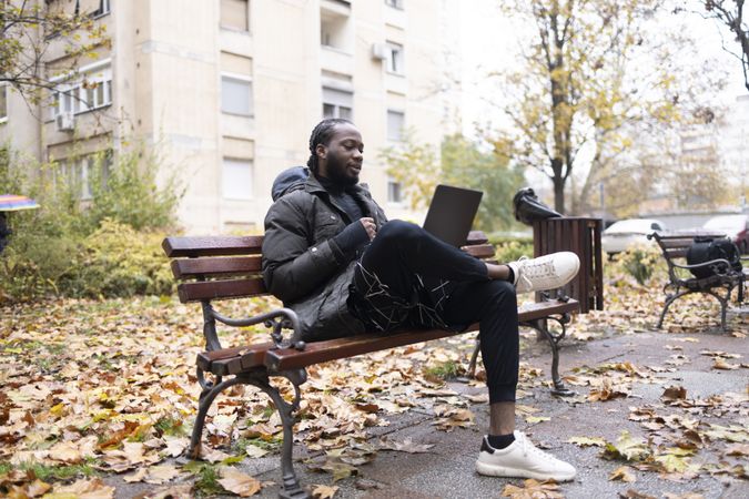 Wireless connectivity enabling digital communication for a man on a bench.
