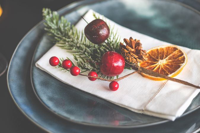 Christmas table setting with decorative berries and dried orange slice