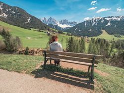 woman admiring the views of Small beautiful village between mountains with snow