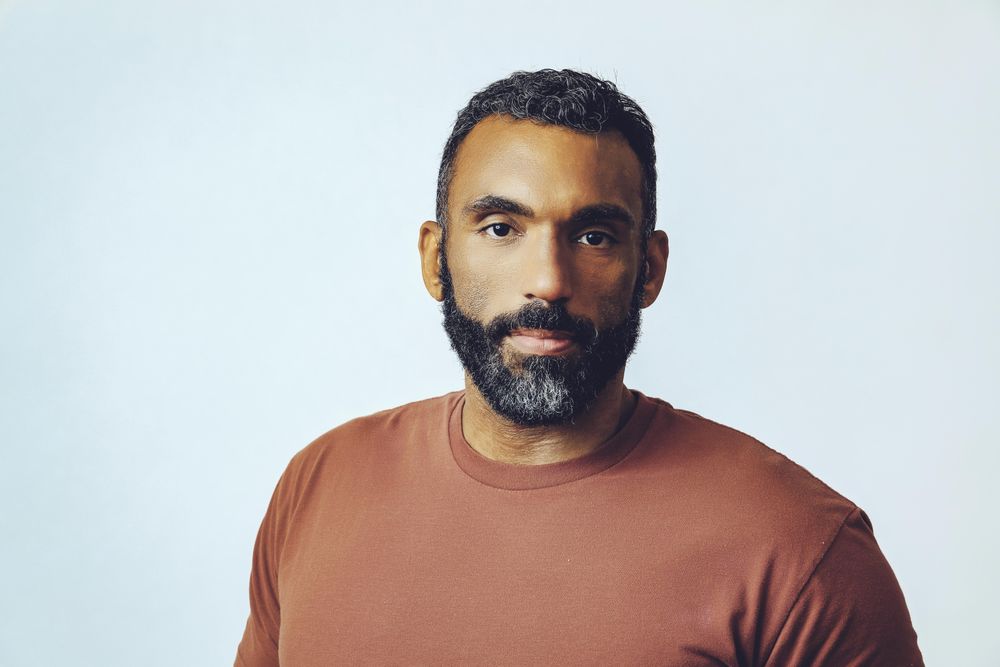 Head shot of Black male in grey studio