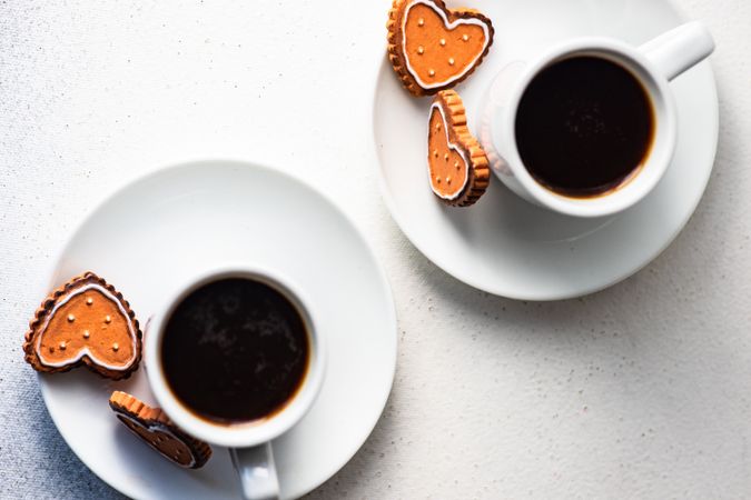 Top view of two coffees with sugar cookies