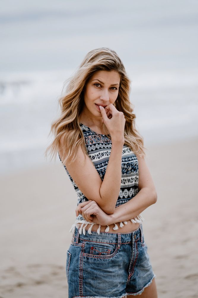 Happy female posing on sandy beach