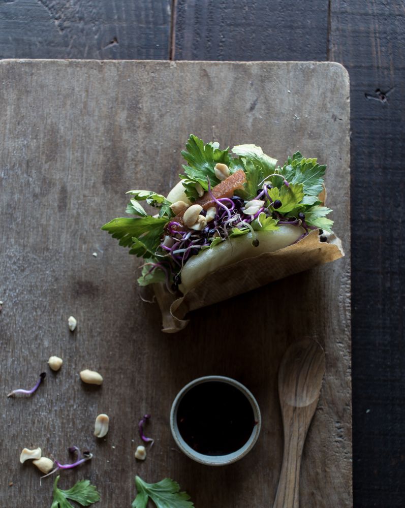 Served Gua Bao sandwich with sauce on board