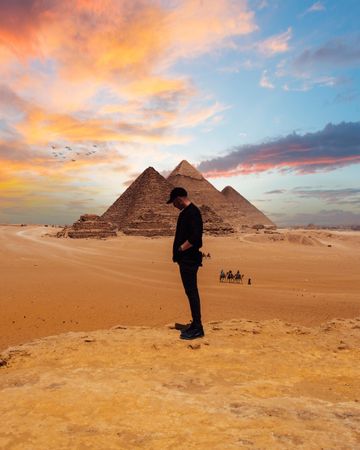 Man standing near pyramids of Giza