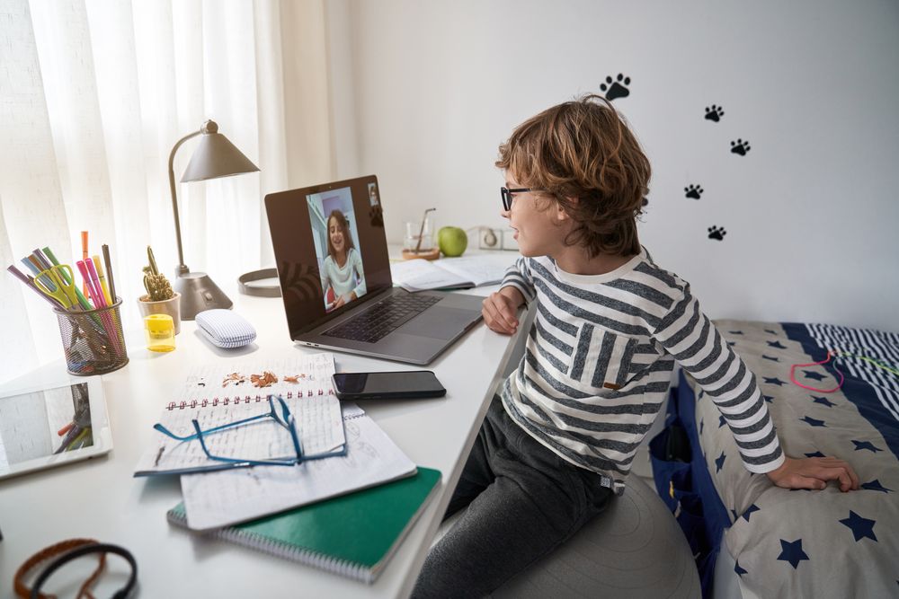 Boy doing homework during video call