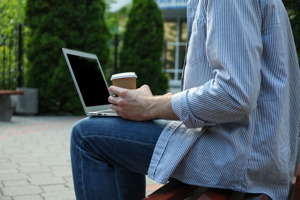 Young student working in a laptop and drinking coffee. Study. University
