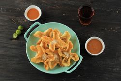 Plate of deep fried wonton snacks on dinner table