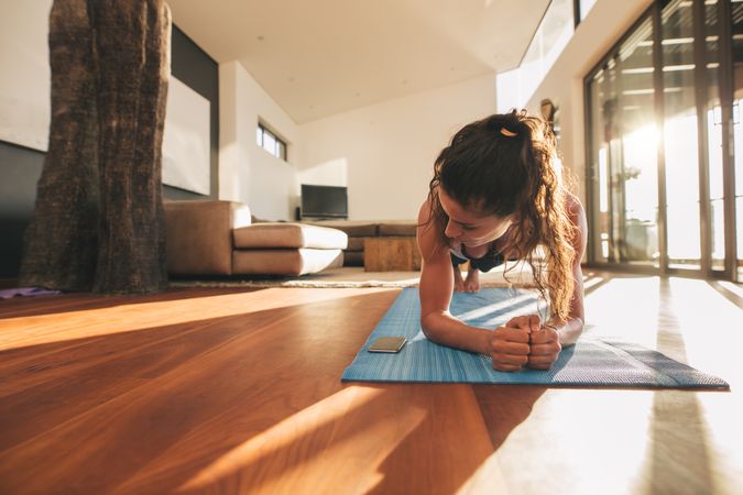 Woman doing planks on a yoga mat