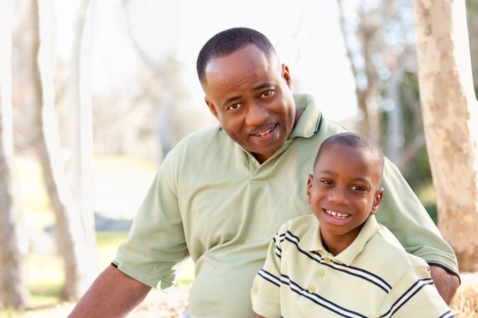Smiling Black Man and Child Having Fun