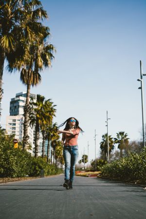 Teen girl walking happily through the streets.