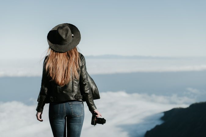 Woman with camera enjoying cloudscape