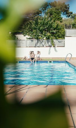 Group of friends sunbathing by the pool