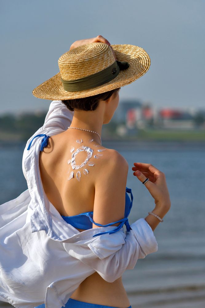 Woman with Sunscreen in sun shape