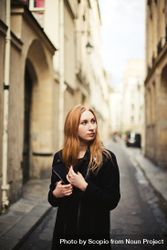 Woman standing in an alley looking away bxmwX0