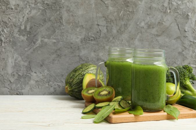 Concept of healthy food with smoothie, vegetables and fruits on wooden table