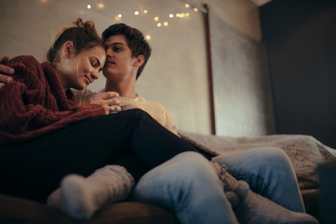 Romantic man and woman relaxing in living room