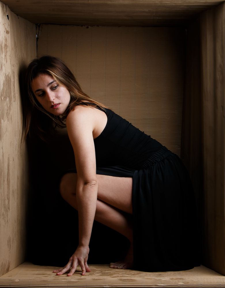 woman sitting in carton box