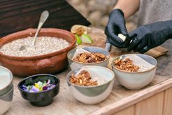 Crop faceless woman cooking chia bowls