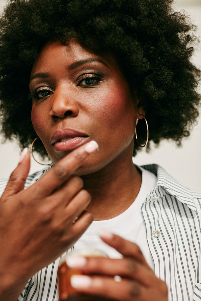 Close up of Black woman with her hand near her face