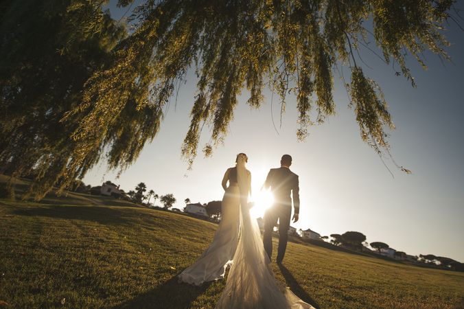 Marriage of woman and man holding hands in park