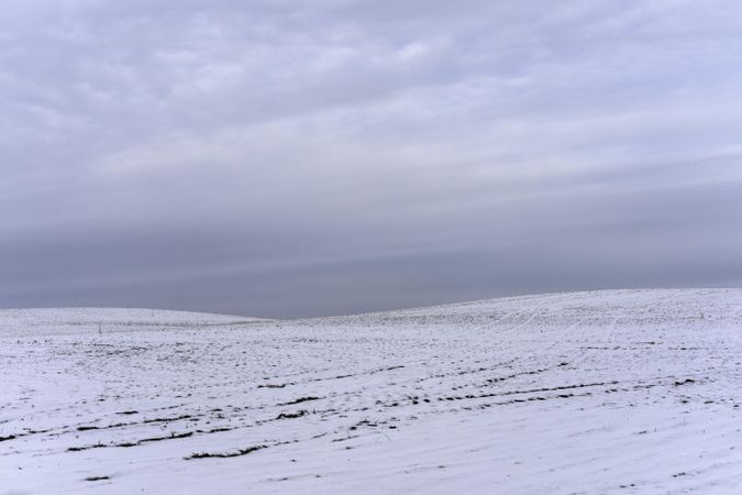A snow covered field on an overcast day