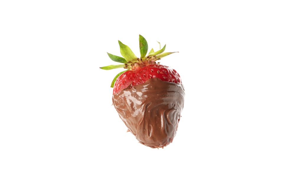 Chocolate fondue. Strawberry in chocolate isolated on plain background