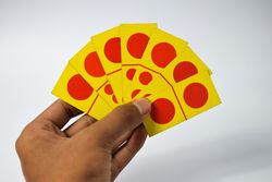 Hands holding seven domino cards