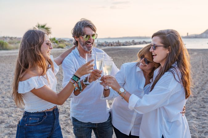 Happy family drinking wine on beach