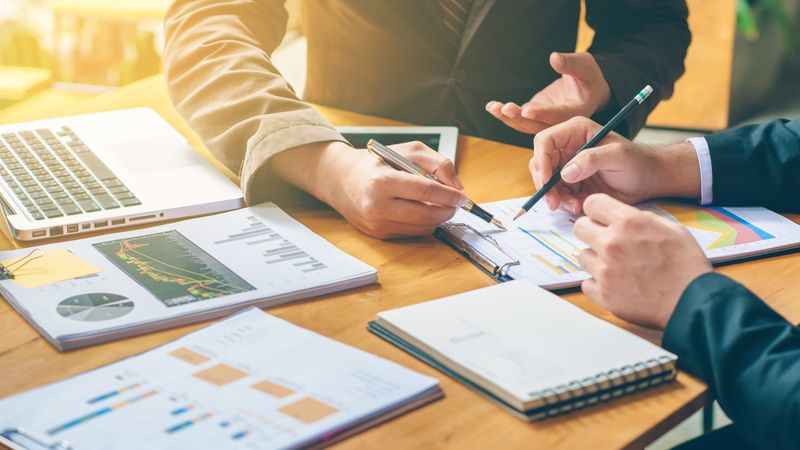 Business people are analyzing and planning business. Business Strategy Consulting