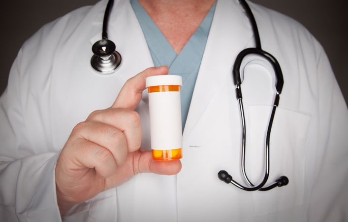 Male Doctor with Blank Medicine Bottle