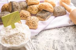 Wheat flour with banner and bread and rolls in the background