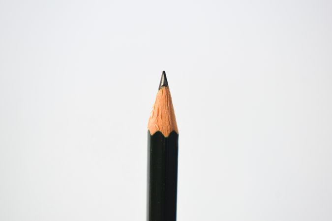 Close up of sharpened pencil straight in center of picture with copy space