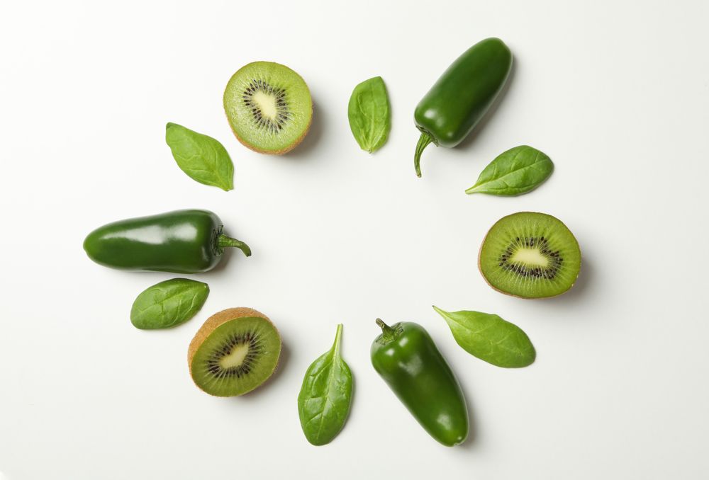 Kiwi, spinach and pepper on blank background