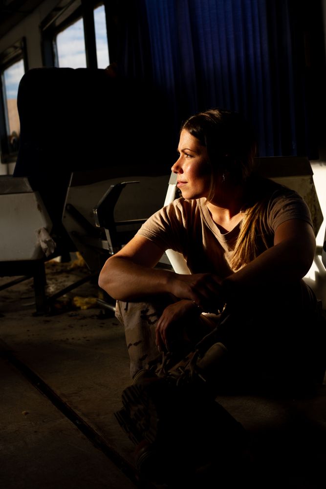 Female soldier on floor of military vehicle