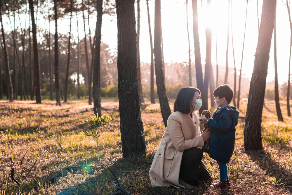 Woman and child surrounded trees