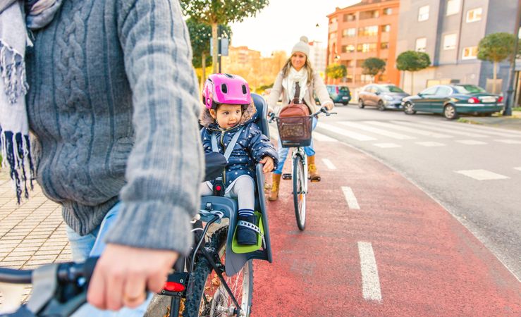 Family on bike ride using bike lane on city streets