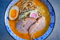 Bowl of delicious pork soup served on table