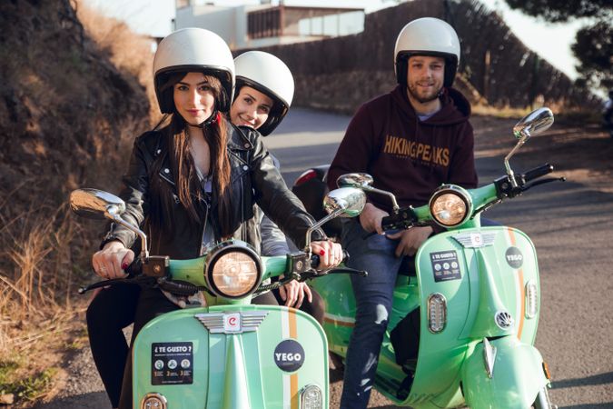 Young people riding motorcycles on city road