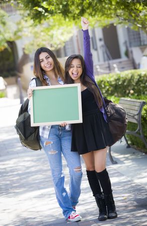 Excited Female Students Holding Blank Chalkboard
