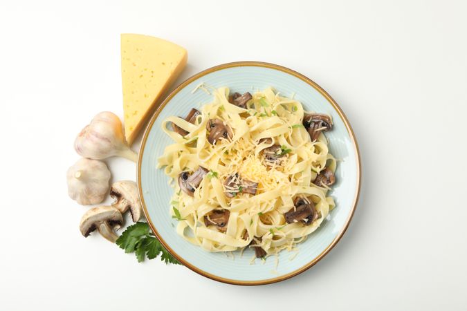Plate with pasta, cheese and mushrooms isolated on blank background