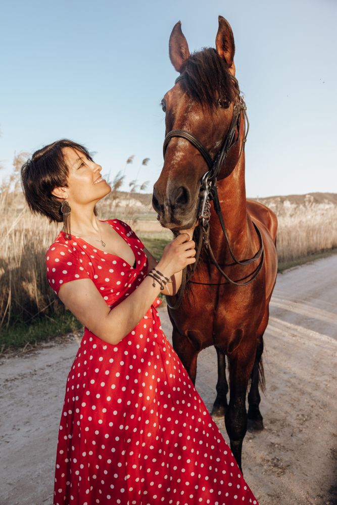 Young woman with horse on ranch