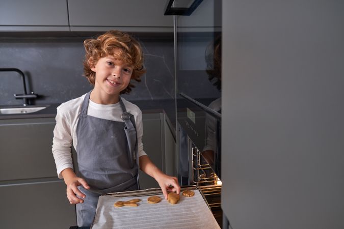 Boy baking cookies on weekend day