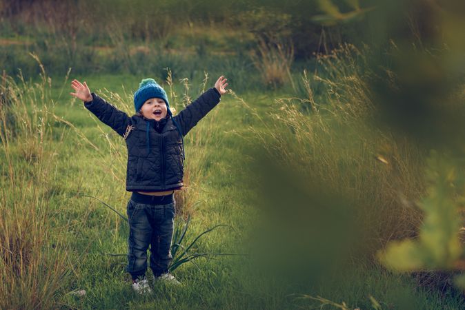 Happy boy on grassy field
