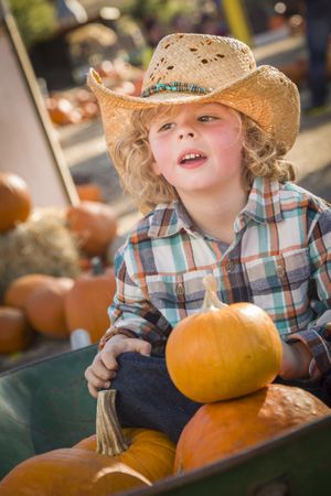 Little Boy in Cowboy Hat at Pumpkin Patch